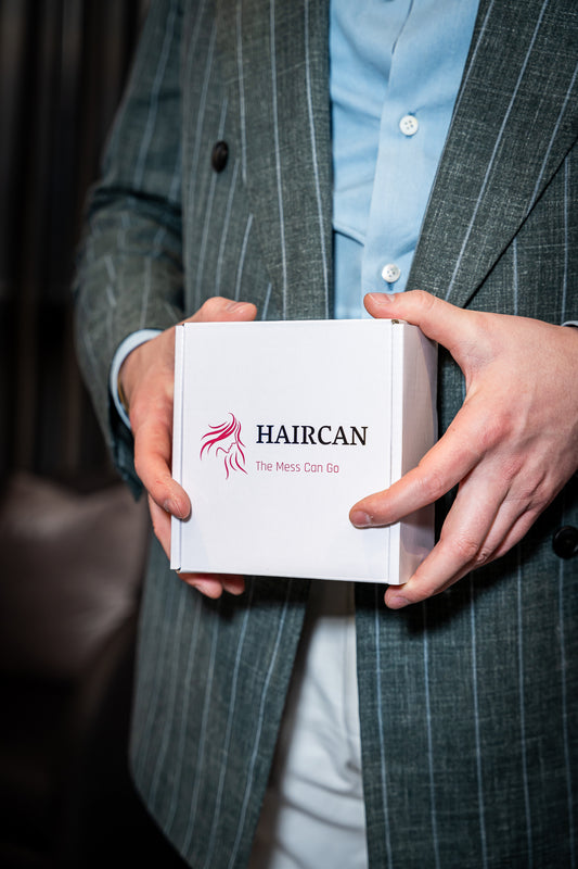 Person holding a white box with 'HAIRCAN' branding. 8