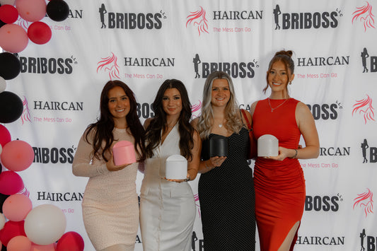 Four women holding awards in front of a branded backdrop with 'Briboss' and 'Haircan'. 7